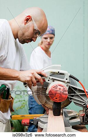 Couple using circular saw View Large Photo Image Stock Photograph - Couple using circular saw. Fotosearch