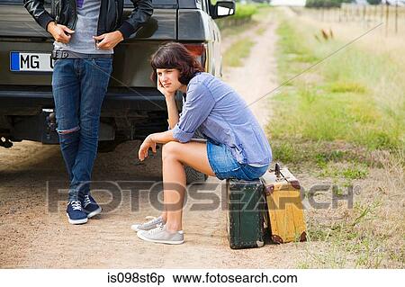 Couple waiting by suv View Large Photo Image Stock Photography - Couple waiting by suv. Fotosearch