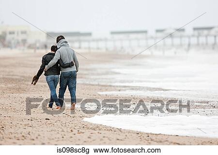 Couple walking by the sea View Large Photo Image Stock Image - Couple walking by the sea. Fotosearch