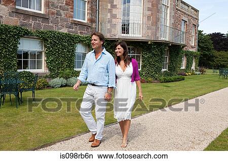 Couple walking in gardens View Large Photo Image Picture - Couple walking in gardens. Fotosearch