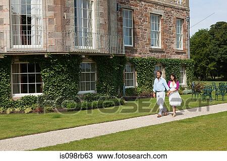 Couple walking in gardens View Large Photo Image Stock Image - Couple walking in gardens. Fotosearch