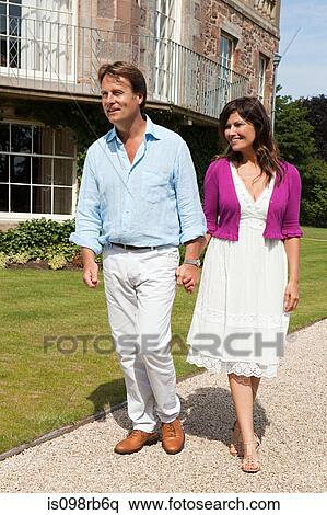 Stock Photography - Couple walking in gardens. Fotosearch