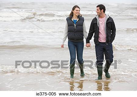 Couple walking in the sea View Large Photo Image Stock Photography - Couple walking in the sea. Fotosearch