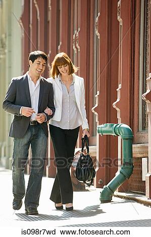 Couple walking together View Large Photo Image Stock Image - Couple walking together. Fotosearch