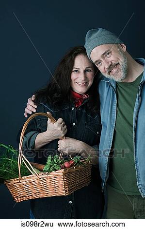 Stock Photograph - Couple with basket of vegetables. Fotosearch