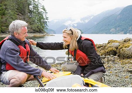 Stock Image - Couple with kayak. Fotosearch