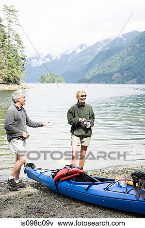 Stock Photo - Couple with kayak. Fotosearch