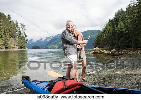 Stock Photo - Couple with kayak. Fotosearch