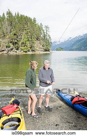 Couple with kayaks View Large Photo Image Picture - Couple with kayaks. Fotosearch