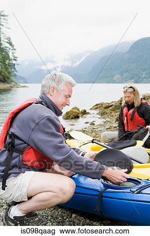 Couple with kayaks View Large Photo Image Stock Image - Couple with kayaks. Fotosearch