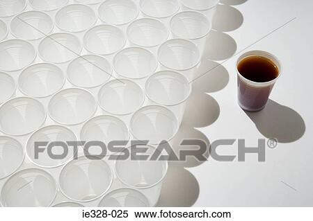 Stock Photography - Cup of cola and rows of empty cups. Fotosearch