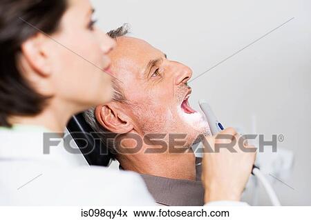 Stock Photo - Dentist and patient. Fotosearch