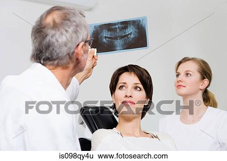 Dentist with patients x-ray View Large Photo Image Stock Photograph - Dentist with patients x-ray. Fotosearch