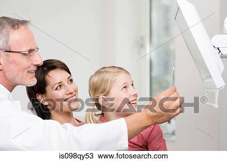 Dentists and patients looking at monitor View Large Photo Image Stock Image - Dentists and patients looking at monitor. Fotosearch