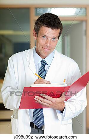 Doctor writing in folder View Large Photo Image Stock Photo - Doctor writing in folder. Fotosearch