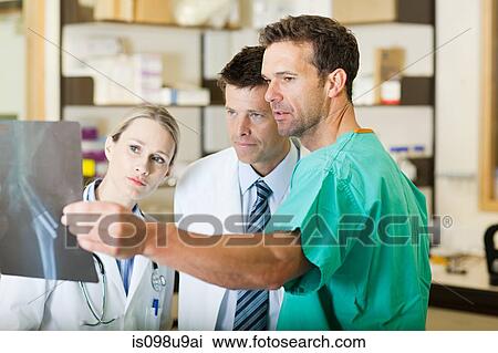 Doctors and surgeon looking at xray View Large Photo Image Stock Image - Doctors and surgeon looking at xray. Fotosearch