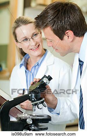 Doctors with microscope View Large Photo Image Picture - Doctors with microscope. Fotosearch