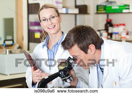 Doctors with microscope View Large Photo Image Stock Photograph - Doctors with microscope. Fotosearch