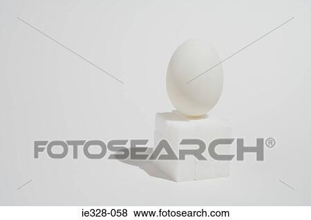 Egg balancing on a block of sugarlumps View Large Photo Image Stock Photo - Egg balancing on a block of sugarlumps. Fotosearch