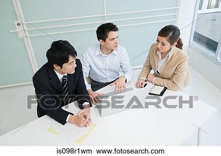 Elevated view of businesspeople having a meeting View Large Photo Image Picture - Elevated view of businesspeople having a meeting. Fotosearch