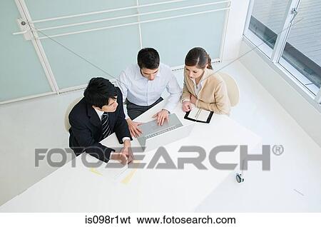 Stock Photograph - Elevated view of businesspeople having a meeting. Fotosearch