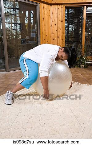 Exhausted woman sleeping on an exercise ball View Large Photo Image Stock Photograph - Exhausted woman sleeping on an exercise ball. Fotosearch