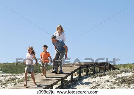 Stock Photograph - Family at the coast. Fotosearch