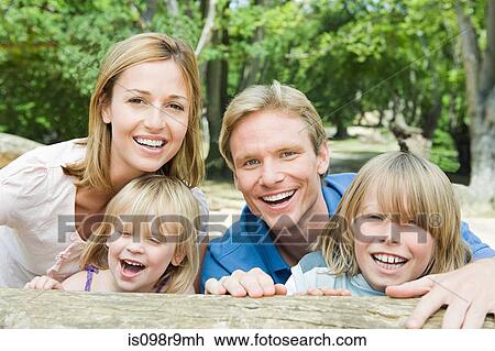 Stock Image - Family by a log. Fotosearch