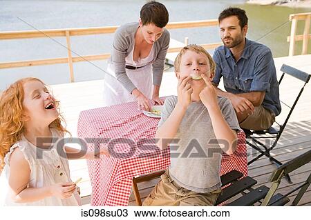 Stock Image - Family enjoying lakeside vacation. Fotosearch