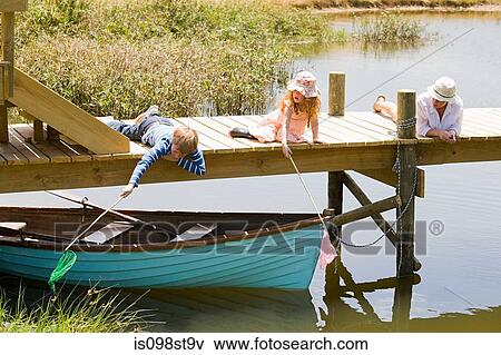 Family enjoying lakeside vacation View Large Photo Image Stock Photo - Family enjoying lakeside vacation. Fotosearch