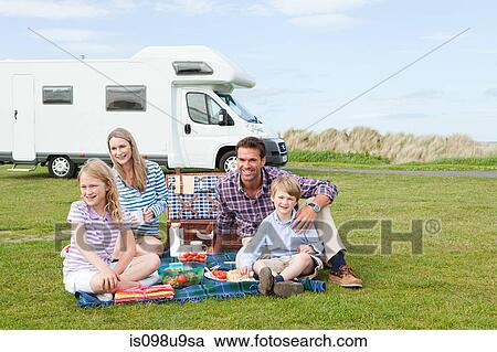 Family having picnic by caravan View Large Photo Image Stock Image - Family having picnic by caravan. Fotosearch