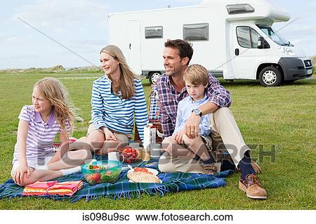 Family having picnic by caravan View Large Photo Image Stock Image - Family having picnic by caravan. Fotosearch