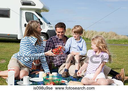 Family having picnic by caravan View Large Photo Image Stock Image - Family having picnic by caravan. Fotosearch