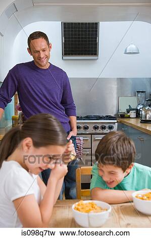 Stock Photo - Family laughing at breakfast. Fotosearch