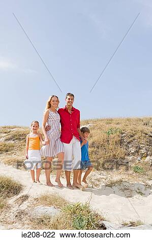 Stock Image - Family on beach. Fotosearch
