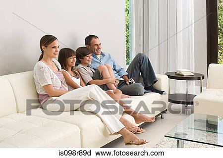 Stock Image - Family relaxing on a sofa. Fotosearch
