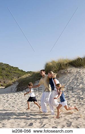 Family running on beach View Large Photo Image Stock Photograph - Family running on beach. Fotosearch