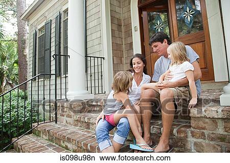 Picture - Family sitting on house steps. Fotosearch