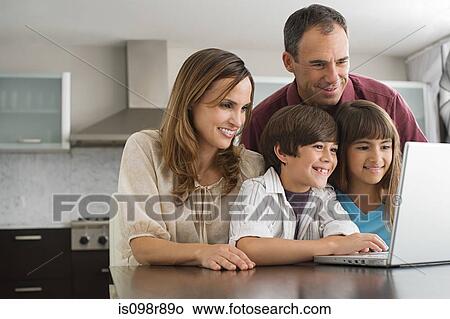 Family using a laptop computer View Large Photo Image Picture - Family using a laptop computer. Fotosearch