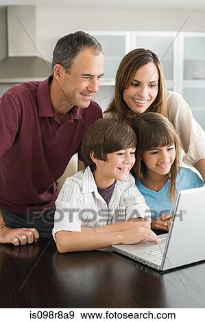 Stock Photo - Family using a laptop computer. Fotosearch