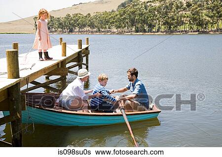 Stock Photograph - Family with rowing boat. Fotosearch