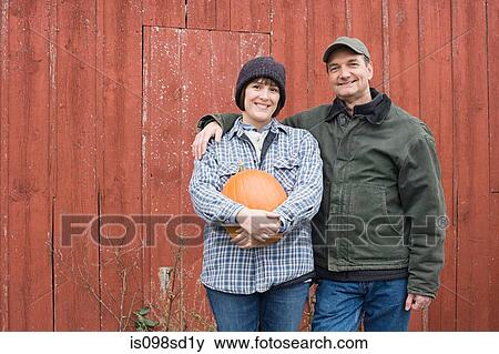 Farmer couple with pumpkin View Large Photo Image Stock Photo - Farmer couple with pumpkin. Fotosearch