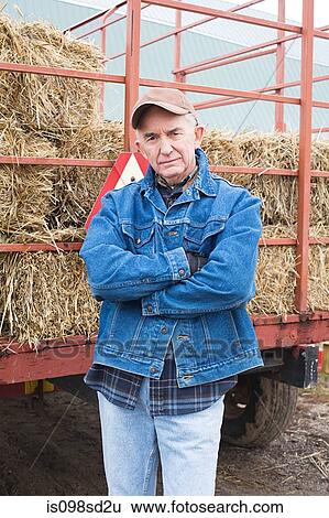Farmer with tractor of hay View Large Photo Image Stock Photograph - Farmer with tractor of hay. Fotosearch