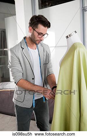 Stock Image - Fashion designer at work. Fotosearch