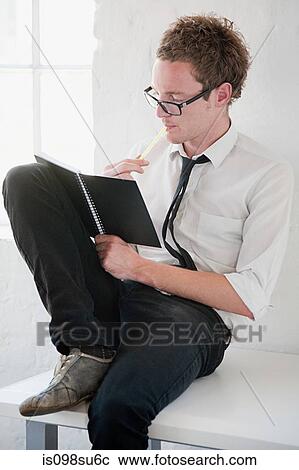 Stock Image - Fashion designer at work. Fotosearch