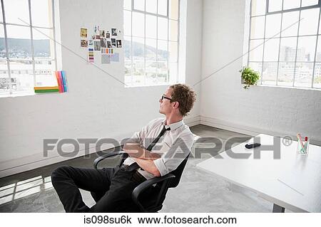 Stock Image - Fashion designer sitting on chair. Fotosearch