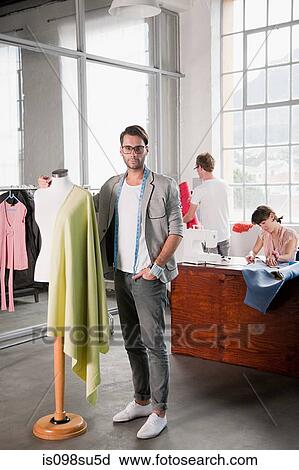 Stock Image - Fashion designers at work. Fotosearch