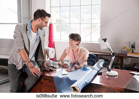 Stock Image - Fashion designers at work. Fotosearch