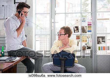 Stock Image - Fashion designers at work. Fotosearch