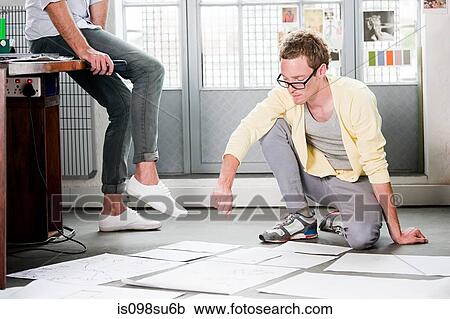 Stock Image - Fashion designers at work. Fotosearch